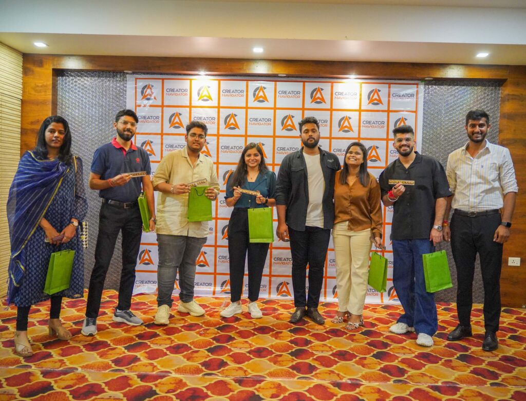 "Group photo of the founder, co-founder, and team members at an event, posing in front of the company branding backdrop."